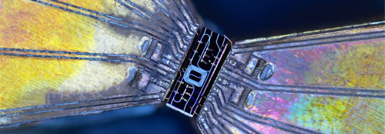 Close-up of circuit board with striking iridescent colouring. 